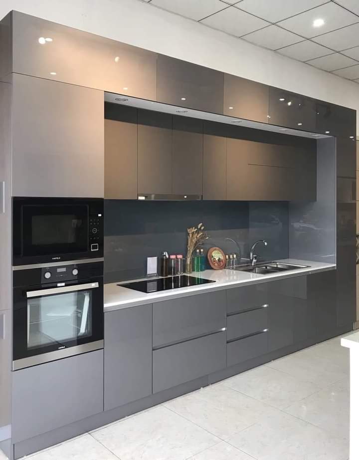 Grey high-gloss built-in kitchen with built-in oven and microwave