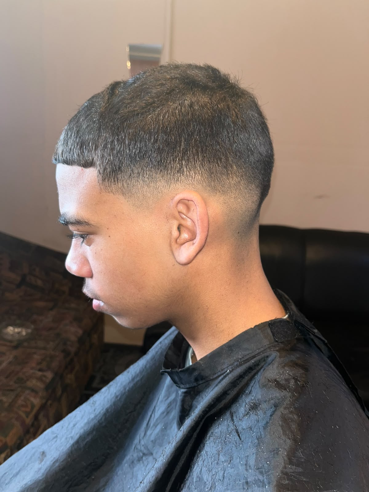 Side profile of a young man with a fresh fade haircut by Michaela