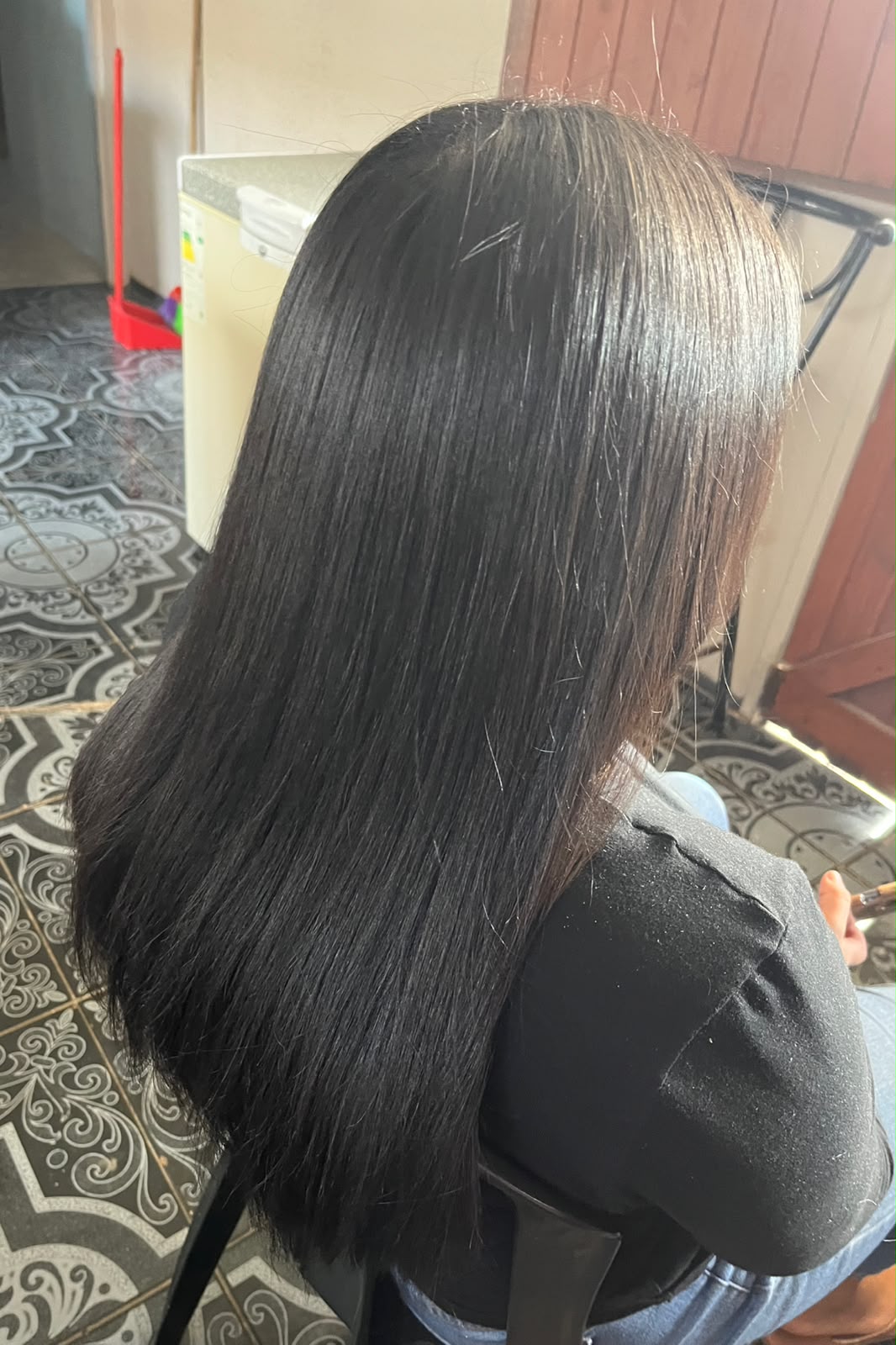 Back view of long straight hair styling by Michaela