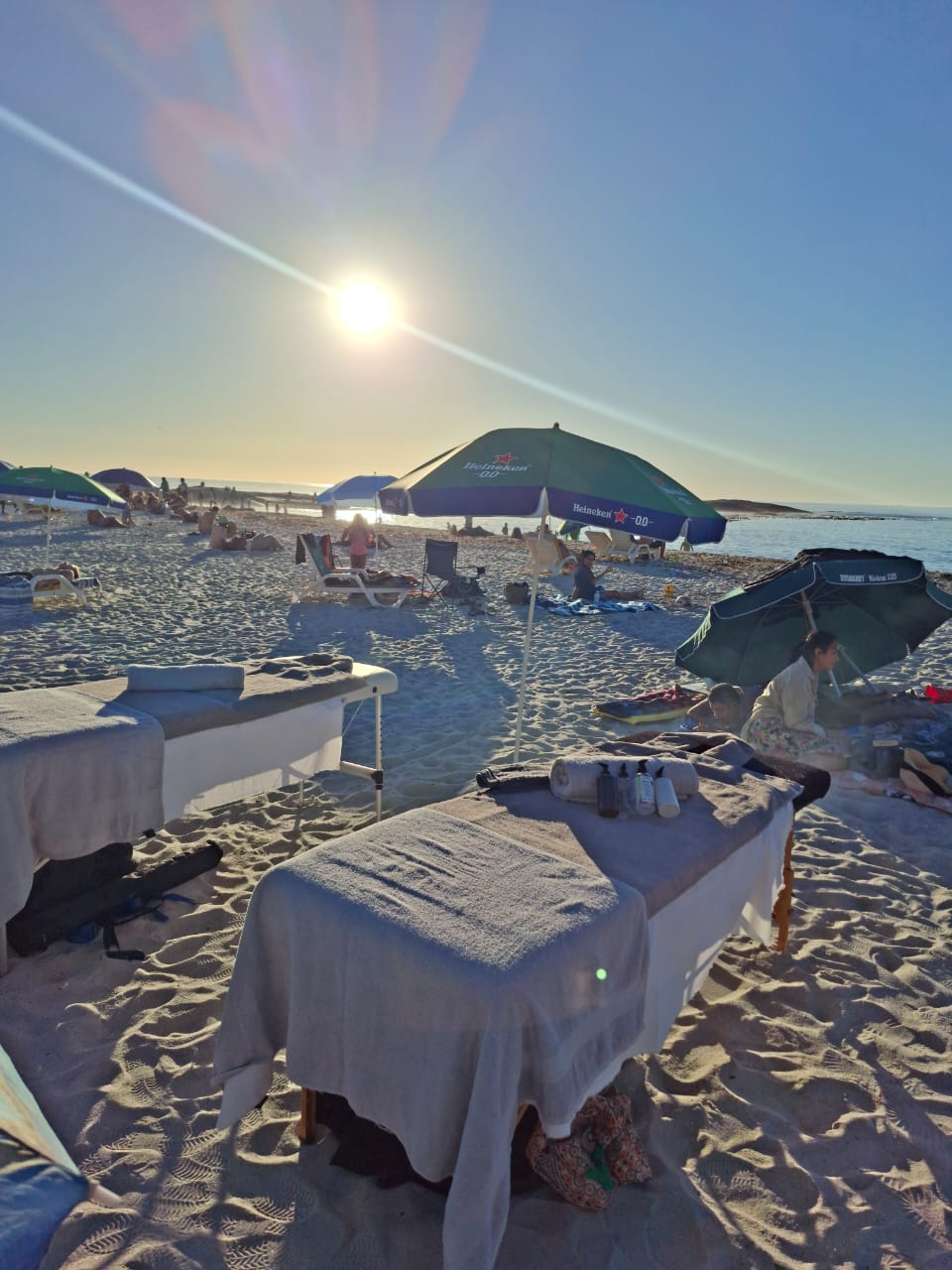 Massage tables prepared on the sandy beach ready for clients