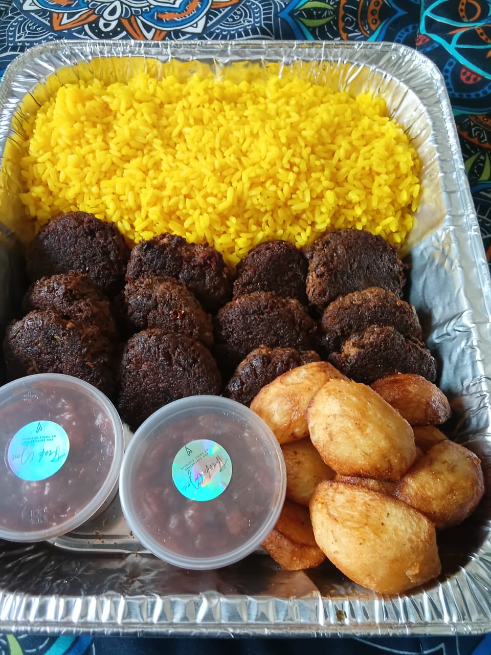 Traditional yellow rice, savory meatballs, and potatoes