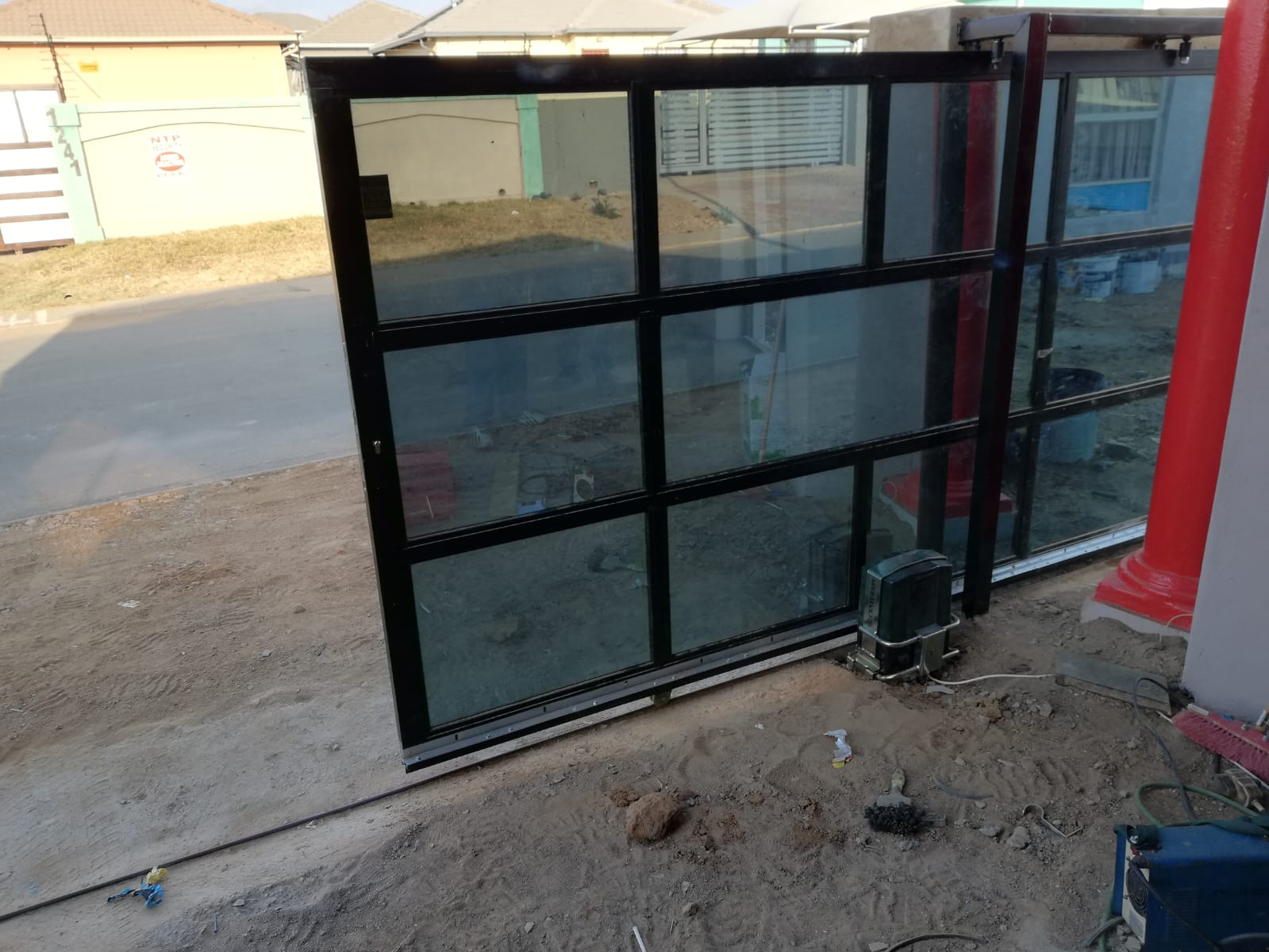 Motorised glass sliding gate installation