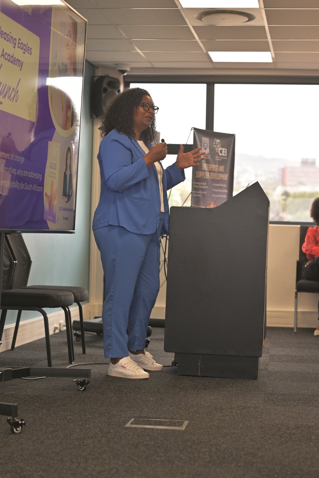 Pamela Andre presenting executive leadership frameworks at podium