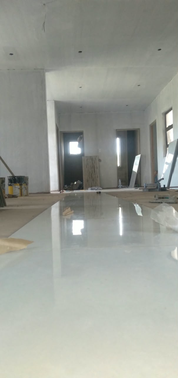 Glossy mirror-like hallway floor reflecting the windows