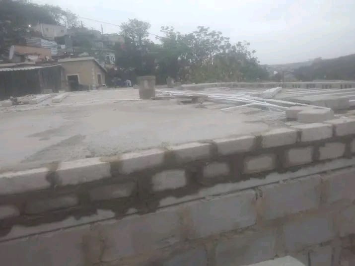 Concrete roof slab with block walls and pipework, under construction, by Mundende Building Construction and Carpentry
