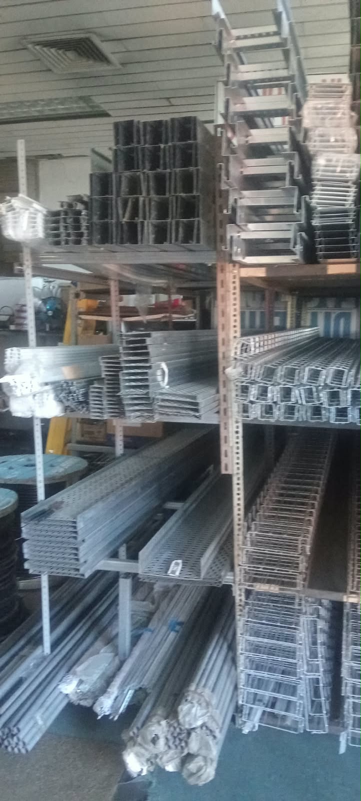 Cable trays, mesh basket tray, trunking and conduit stacked on racking
